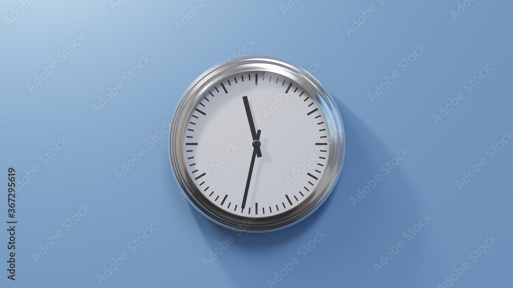Glossy chrome clock on a blue wall at thirty-two past eleven. Time is 11:32 or 23:32 Glossy chrome clock on a blue wall at thirty-two past eleven. Time is 11:32 or 23:32