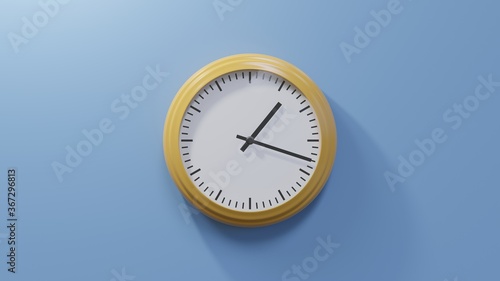 Glossy orange clock on a blue wall at eighteen past one. Time is 01:18 or 13:18