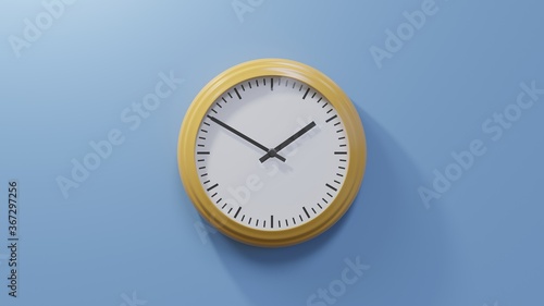 Glossy orange clock on a blue wall at ten to two. Time is 01:50 or 13:50