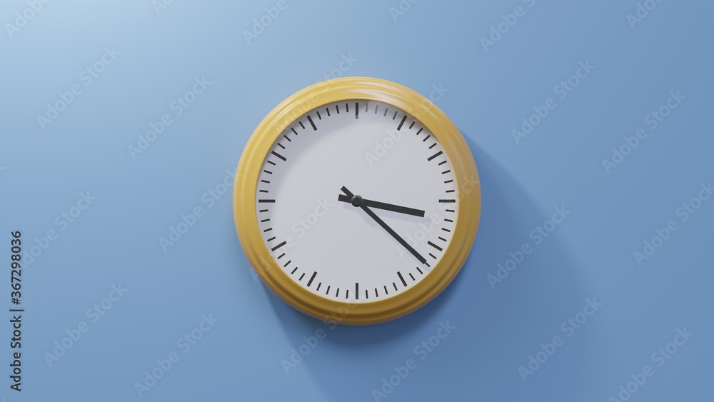 Glossy orange clock on a blue wall at twenty-two past three. Time is 03:22 or 15:22