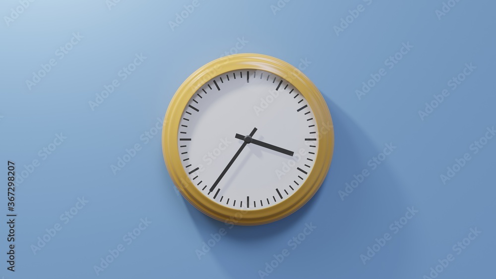 Glossy orange clock on a blue wall at thirty-six past three. Time is 03:36 or 15:36 Glossy orange clock on a blue wall at thirty-six past three. Time is 03:36 or 15:36