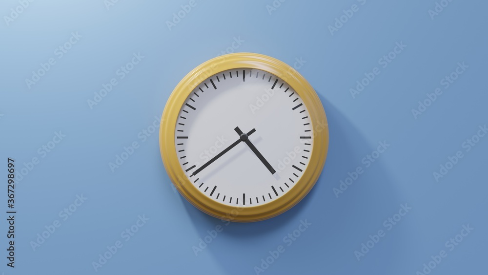 Glossy orange clock on a blue wall at thirty-nine past four. Time is 04:39 or 16:39 Glossy orange clock on a blue wall at thirty-nine past four. Time is 04:39 or 16:39