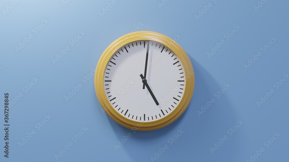 Glossy orange clock on a blue wall at one past five. Time is 05:01 or 17:01 Glossy orange clock on a blue wall at one past five. Time is 05:01 or 17:01