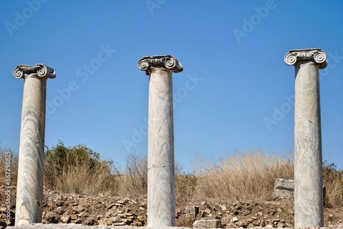 Three classical Ionic marble columns at ruin ancient city of Perge, near Antaliya, Turkey. photo