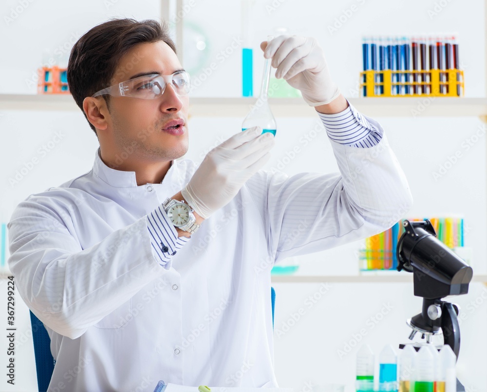 Young chemist student working in lab on chemicals Young chemist student working in lab on chemicals