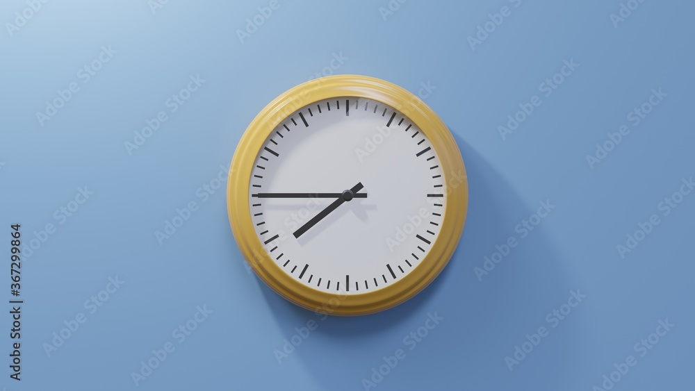 Glossy orange clock on a blue wall at quarter to eight. Time is 07:45 or 19:45 Glossy orange clock on a blue wall at quarter to eight. Time is 07:45 or 19:45