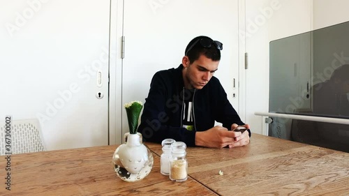 Young men surfing on his smartphone in a coffee shop