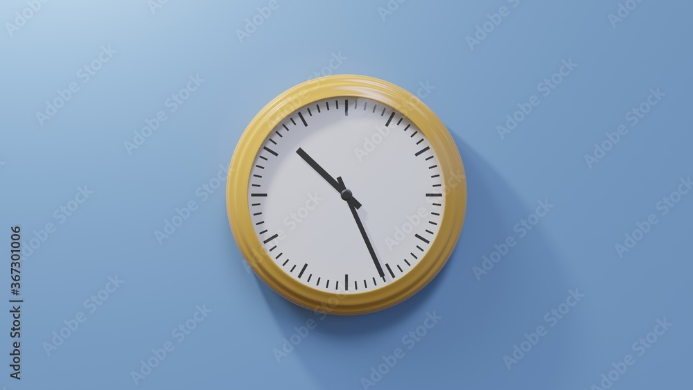 Glossy orange clock on a blue wall at twenty-six past ten. Time is 10:26 or 22:26 Glossy orange clock on a blue wall at twenty-six past ten. Time is 10:26 or 22:26