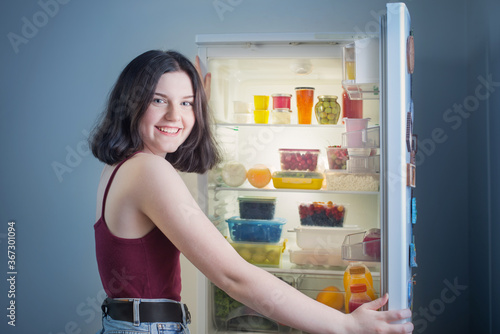 smile girl near refrigerator at night