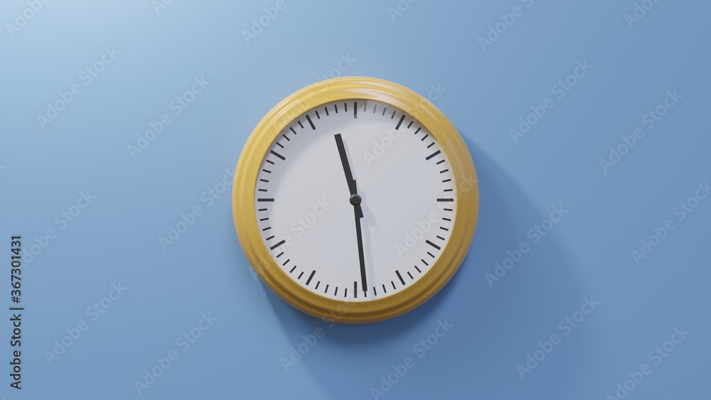 Glossy orange clock on a blue wall at twenty-nine past eleven. Time is 11:29 or 23:29 Glossy orange clock on a blue wall at twenty-nine past eleven. Time is 11:29 or 23:29