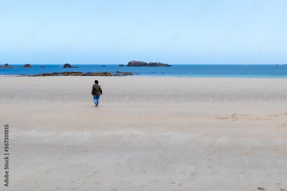 woman walking on a sandy beach