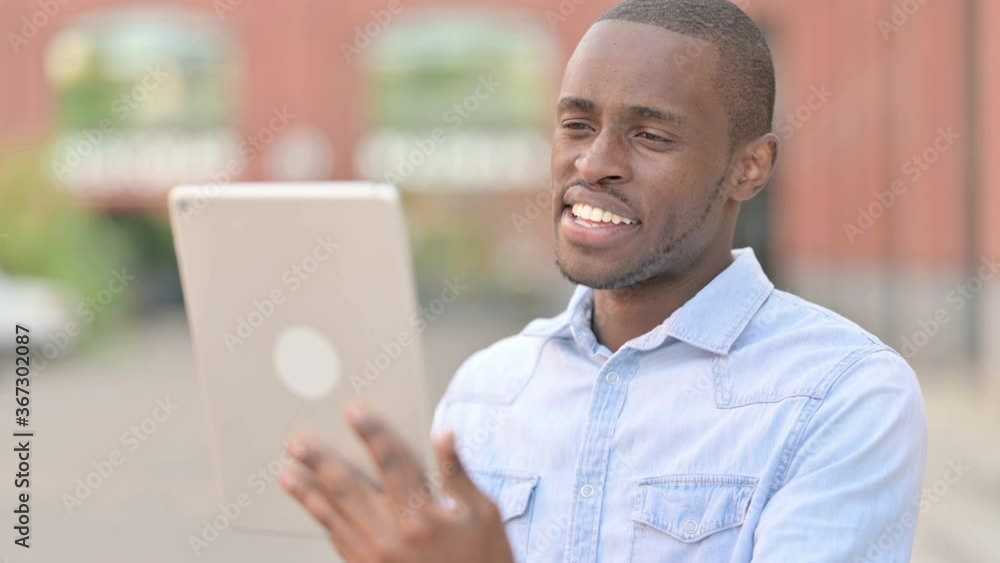 Outdoor Portrait of Video Call on Tablet by Attractive African Man Outdoor Portrait of Video Call on Tablet by Attractive African Man