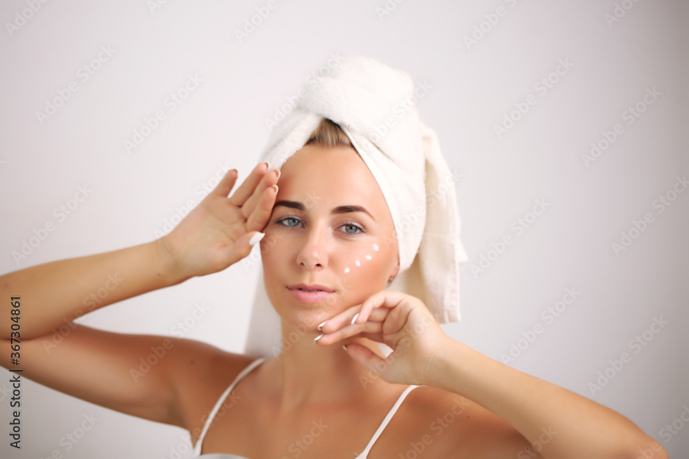 portrait of a beautiful woman applying face cream for skin care portrait of a beautiful woman applying face cream for skin care