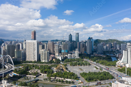 Obraz na płótnie Aerial view of modern city and mountains w salonie