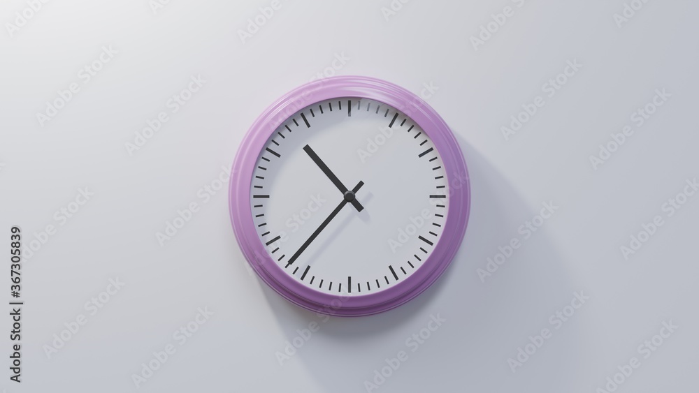 Glossy pink clock on a white wall at thirty-seven past ten. Time is 10:37 or 22:37 Glossy pink clock on a white wall at thirty-seven past ten. Time is 10:37 or 22:37