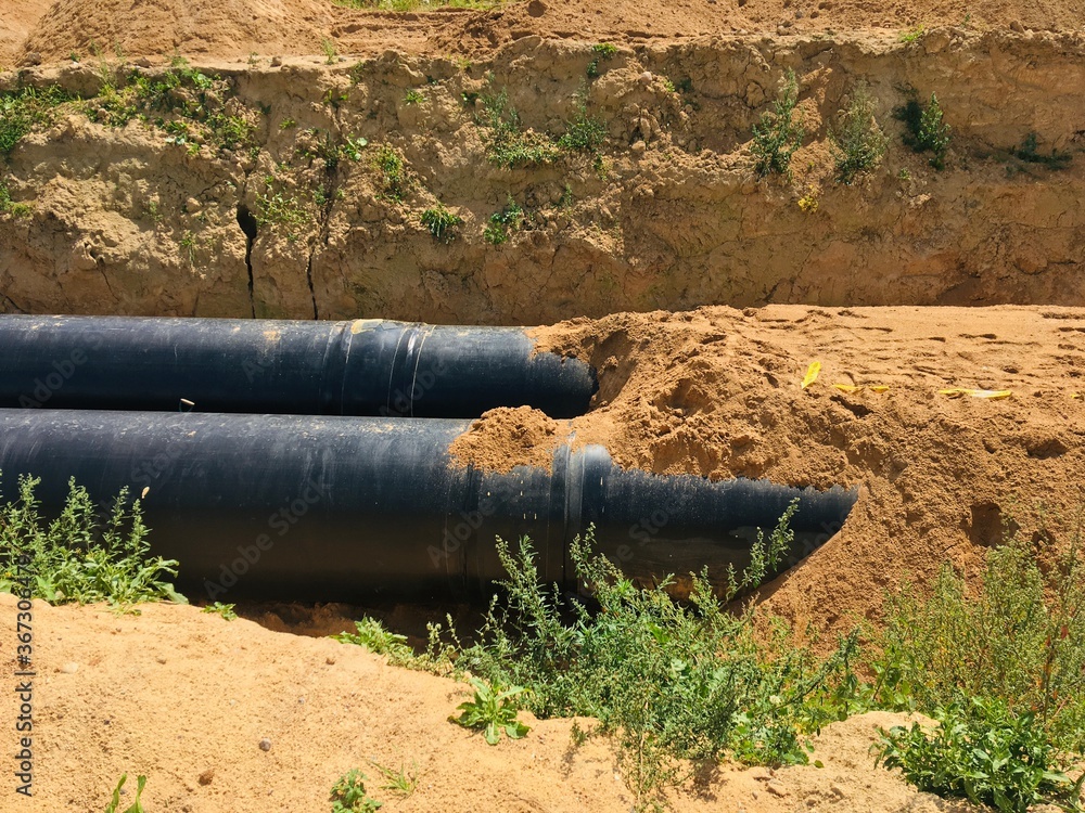 new insulated water pipes in the trench construction site . urban sewerage infrastructure new insulated water pipes in the trench construction site . urban sewerage infrastructure