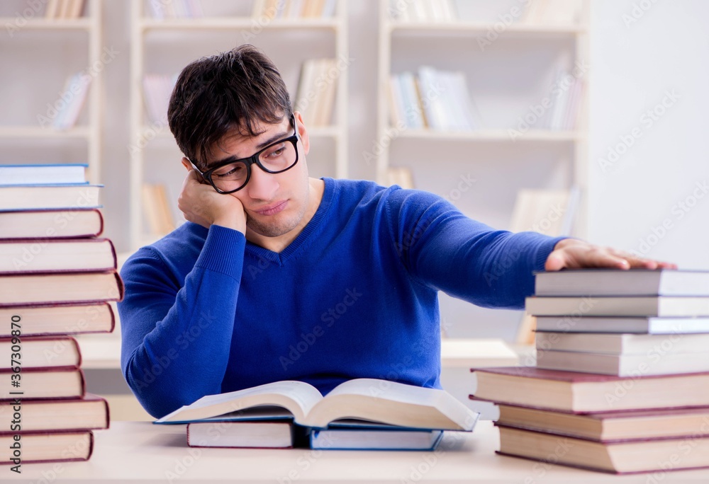 Male student preparing for exams in college library Male student preparing for exams in college library
