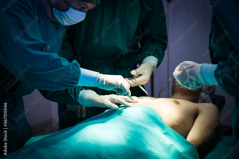 Medical team performing the surgery in the operating room at the hospital. Medical team performing the surgery in the operating room at the hospital.