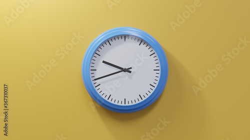 Glossy blue clock on a orange wall at forty-two past nine. Time is 09:42 or 21:42