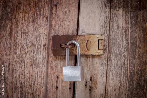 Locked padlock with at door.select focus © jirateep