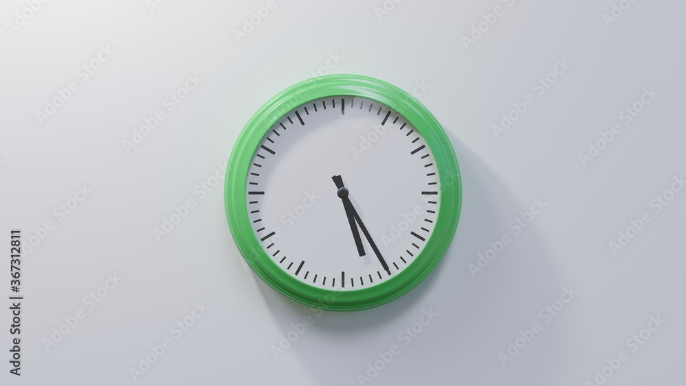 Glossy green clock on a white wall at twenty-five past five. Time is 05:25 or 17:25