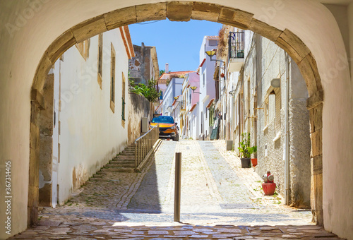 One of the streets of the old town of Lagos in Algarve, seen through the arch. 