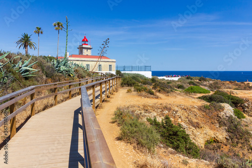 Famous lighthouse and wooden footbridge of the Ponta da Piedade in Algarve reagion, South of Portugal.  photo