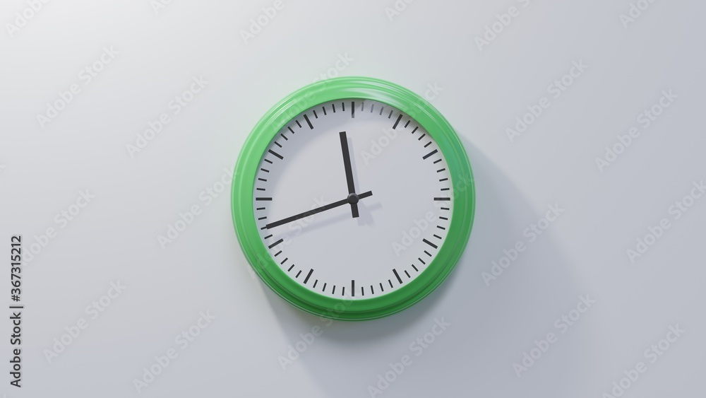 Glossy green clock on a white wall at forty-two past eleven. Time is 11:42 or 23:42 Glossy green clock on a white wall at forty-two past eleven. Time is 11:42 or 23:42