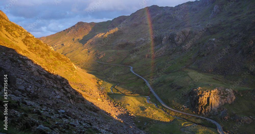 Scenic view of Llanberis Pass with rainbow