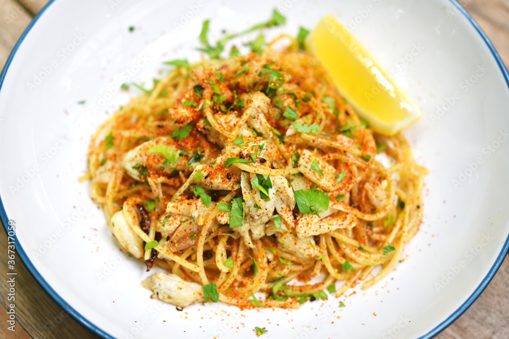 Spicy crab pasta, Seafood spaghetti with chilli pepper, Favorite fusion italian dish in restaurant. Spicy crab pasta, Seafood spaghetti with chilli pepper, Favorite fusion italian dish in restaurant.