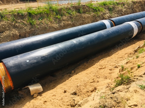 new insulated water pipes in the trench construction site . urban sewerage infrastructure