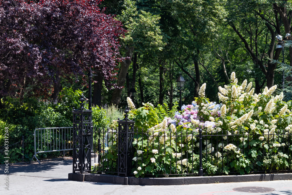 Washington Square Park Entrance during Summer with Beautiful Flowers and Plants in Greenwich Village of New York City