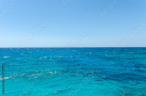 Beautiful emerald sea and clear blue sky. Small waves
