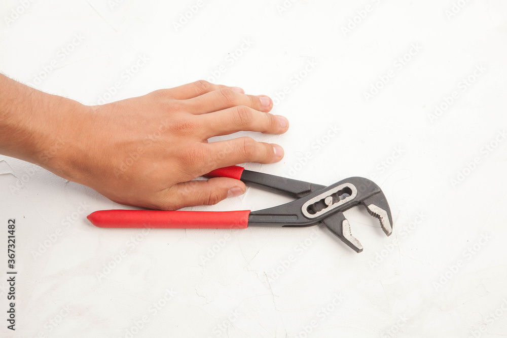 Pliers in hand and icholized on a white background. Home renovation tools. Pliers in hand and icholized on a white background. Home renovation tools.