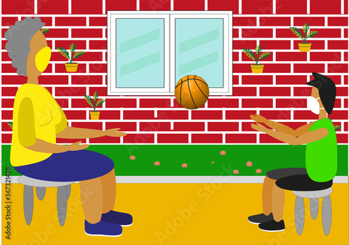 Abuela y nieto con mascarilla jugando con el balón en el jardín de casa