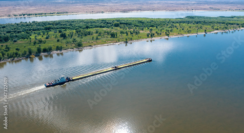AA barge loaded with natural sulfur goes up the Volga River near Astrakhan. Aerial photography photo