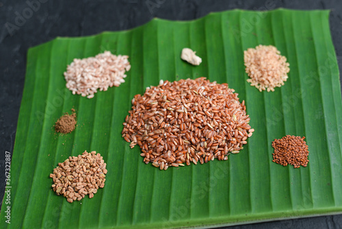 Ayurvedic porridge, Karkidaka Kanji herbal gruel ingredients on banana leaf Kerala South India. Ayurveda diet health drink for immunity, cleanse the body. Top view medicinal porridge Indian veg food