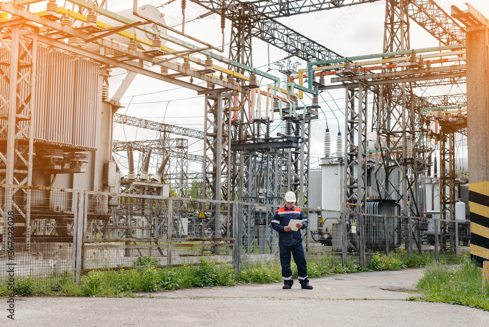The energy engineer inspects the equipment of the substation. Power engineering. Industry The energy engineer inspects the equipment of the substation. Power engineering. Industry