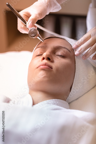 Wet cleaning of the face with a special device. Cleaning, softening and moisturizing the female face