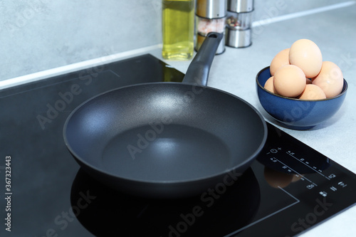 Frying pan on modern induction cooker. 