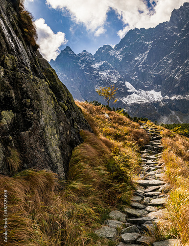 Stone path in the mountains. Hiking trail up the Litvorova valley in Slovak High Tatras in autumn. photo