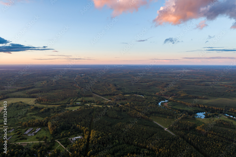 Beautiful sunset over the small town. Fields and trees around. Aerial photography. Beautiful sunset over the small town. Fields and trees around. Aerial photography.