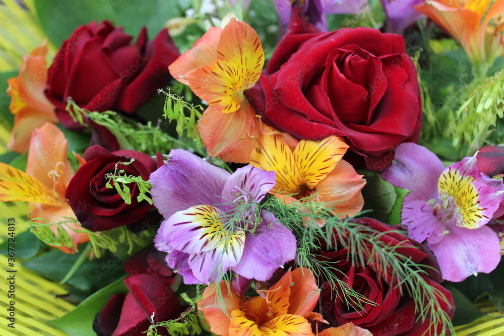 bouquet of colorful flowers with red roses and alstroemeria on background bouquet of colorful flowers with red roses and alstroemeria on background