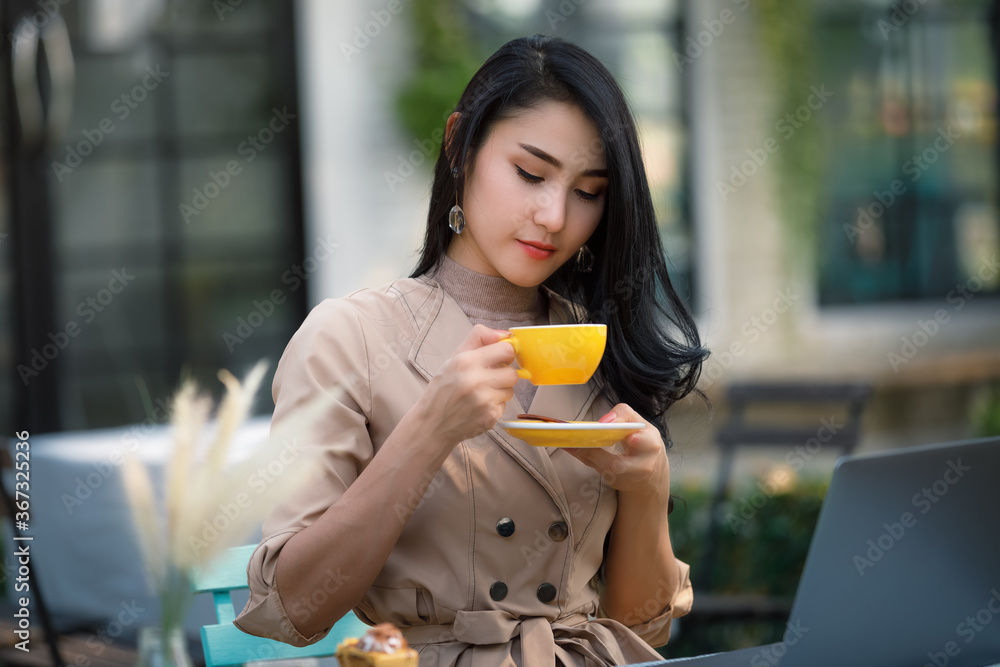 young freelance Business women sitting wood table in garden and relaxing drinking coffee young freelance Business women sitting wood table in garden and relaxing drinking coffee