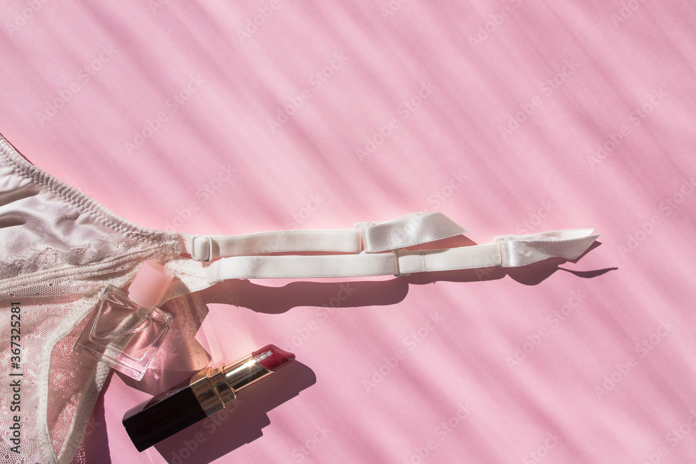 Naklejka premium Lingerie garter for stockings on pink background