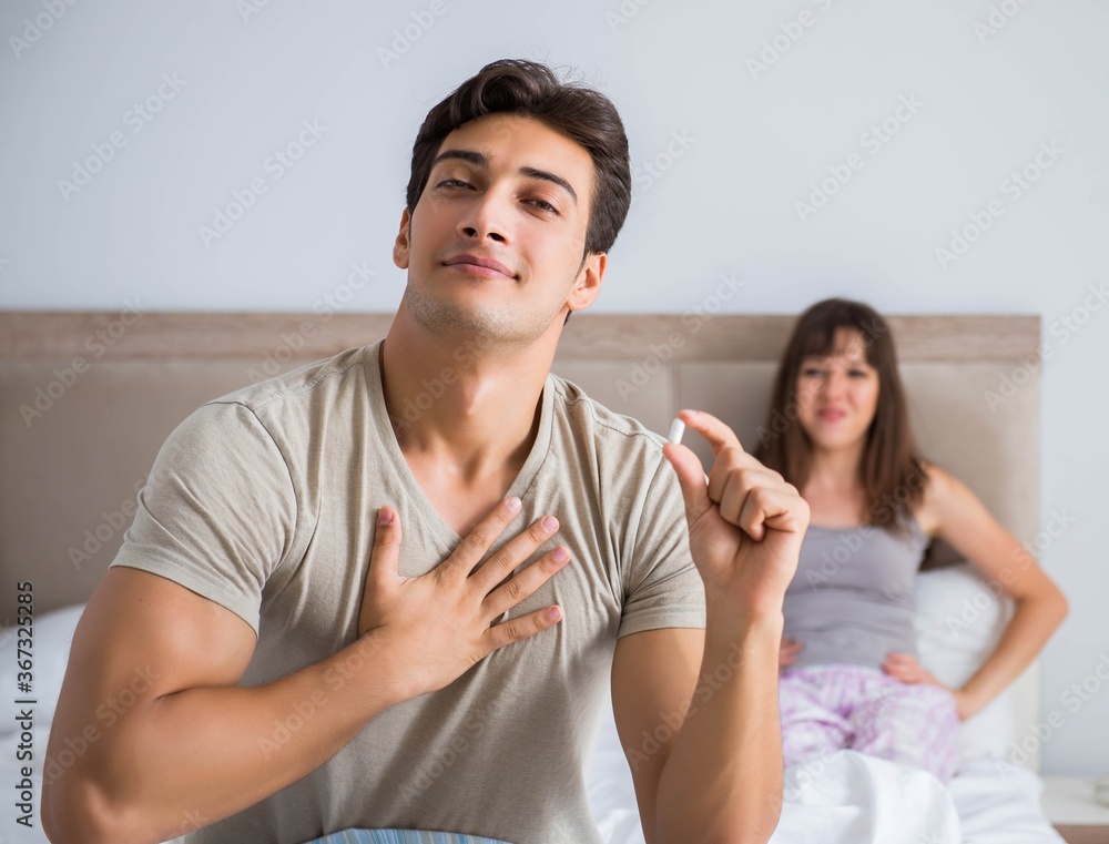 Man suffering from impotency with pill Man suffering from impotency with pill