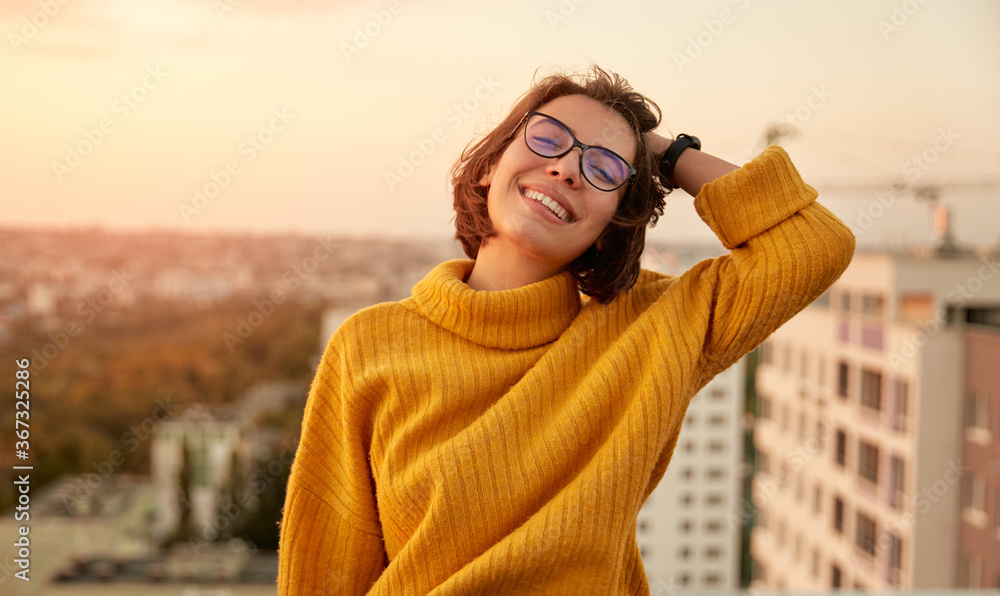 Happy woman resting on roof