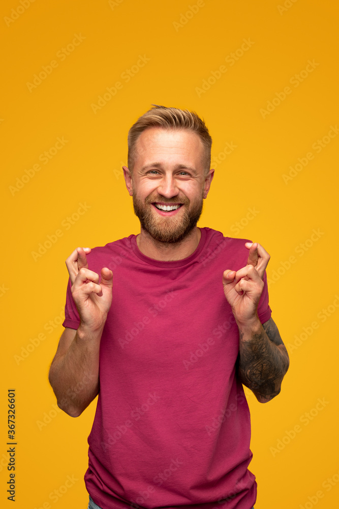 Happy hipster man with crossed fingers Happy hipster man with crossed fingers