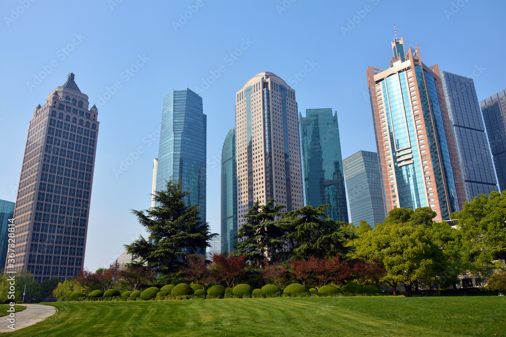 different colorful skyscrapers under blue sunny day in Lujiazui Park in Pudong of Shanghai 