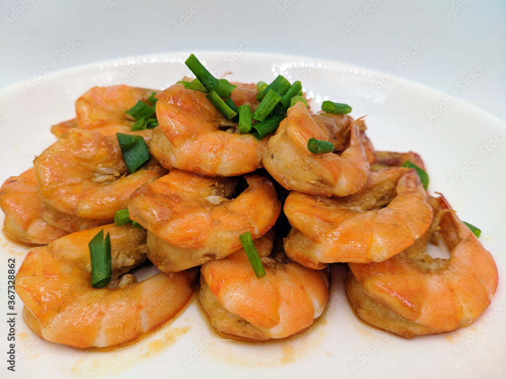 braised shrimp with oil and sauce on the white plate braised shrimp with oil and sauce on the white plate
